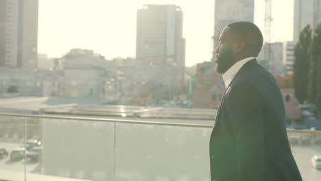 Afro-businessman-dancing-at-street.-Excited-man-celebrating-success-outdoors