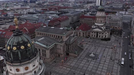 Aerial-with-of-Concert-hall-on-Gendarmenmarkt.-People-walking-on-square-around.-Pair-of-churches-with-domes.-Berlin,-Germany