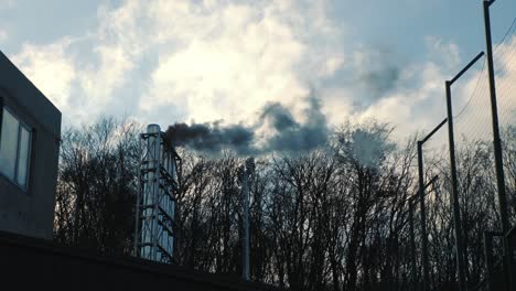 atmospheric polluting industry. black smoke coming out of the chimney. air emissions that change ecology and climate change