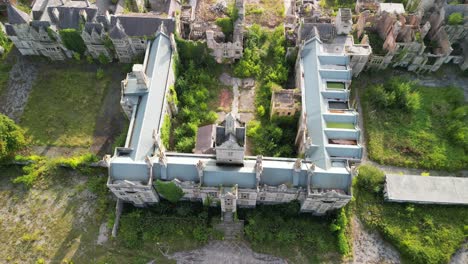 haunted denbigh lunatic asylum, north wales, aerial dronie revealing site, sunny afternoon