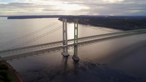 wide aerial shot pulling away from tacoma narrows bridge at sunset, circa 2015