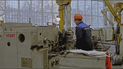 worker operating a lathe in a factory