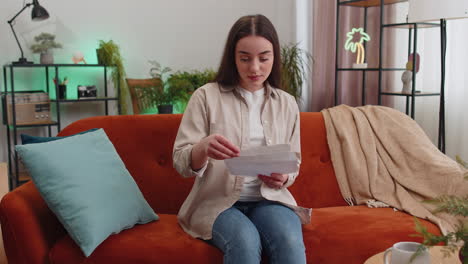 woman open envelope letter reads it feel happy career growth advance promotion bank loan approve