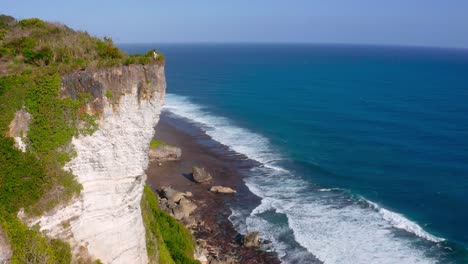 majestic cliff standing tall beside coastline of beach