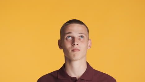 happy blond guy looking and pointing up