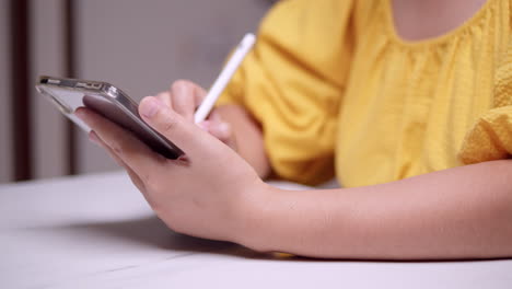 Detail-of-female-hands-writing-with-pen-on-digital-tablet