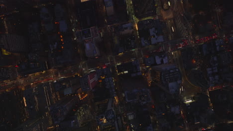 Aerial-birds-eye-overhead-top-down-view-of-midtown-at-night.-Heavy-traffic-in-evening-streets-and-avenues.-Manhattan,-New-York-City,-USA