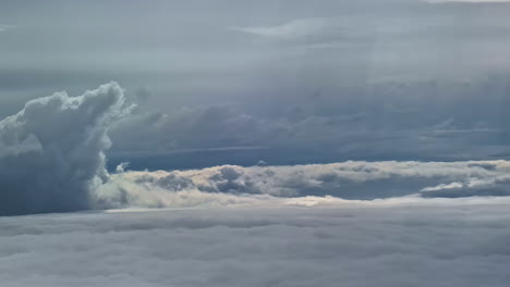 majestic aerial view of layered clouds and dramatic sky captured from an airplane window during flight