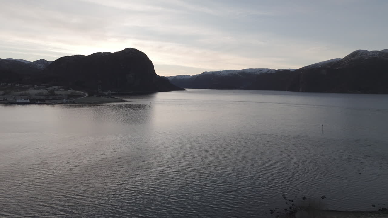 Drone shot flying over the water near Forsand Norway Lysefjord during sunset on a clear day LOG