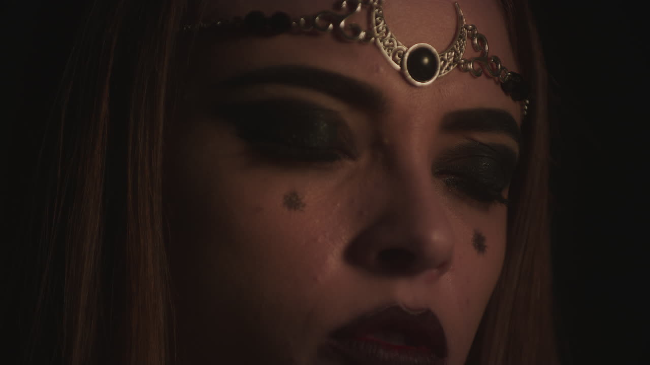 Closeup Face of Wiccan Lady Practices Speaking to Demonic Spirits, tilt up reveal