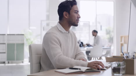 Young-businessman-using-a-computer-in-a-trendy