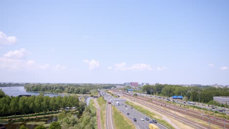 aerial view of the a10 motorway with traffic near amsterdam with schiphol airport in the background, the netherlands