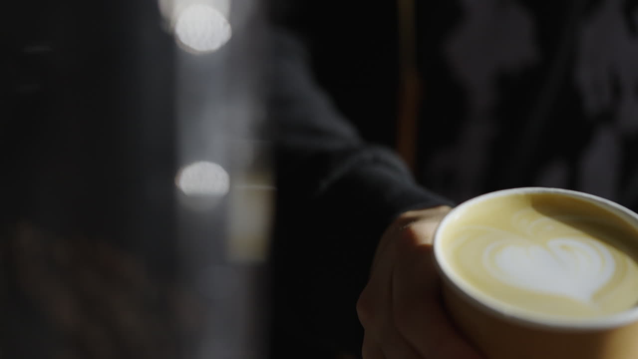 Barista holding a cup of latte