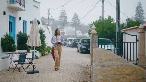 pretty woman walking old mediterranean town. focused girl exploring architecture