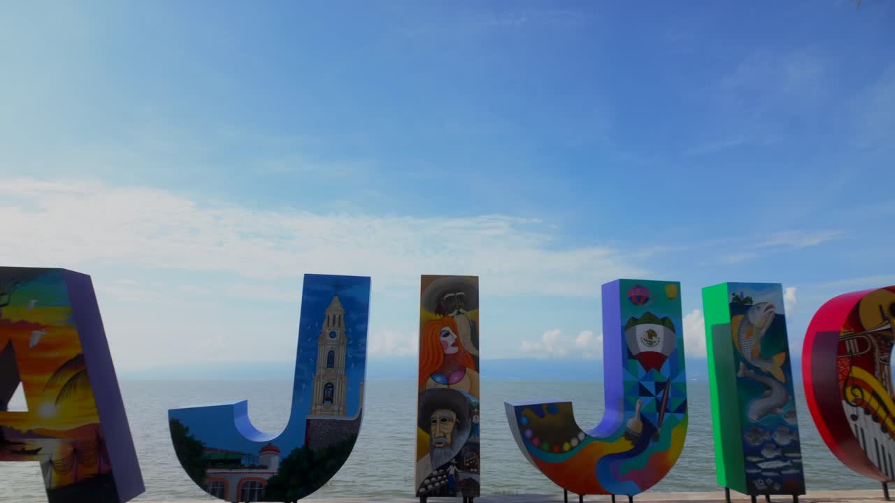Colorful Ajijic Lakeside Sign Framed by Palm Trees and Open Sky