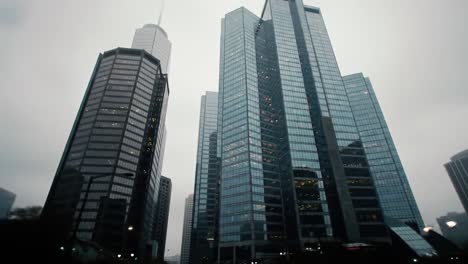 aerial views of urban skyscrapers shrouded in mist: exploring the architectural majesty of city towers beneath a foggy skyline