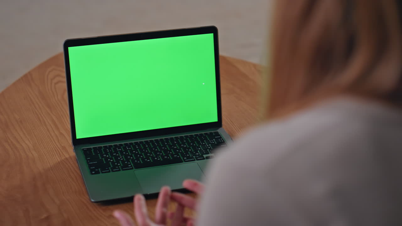 Businesswoman video calling chroma key laptop on home close up. Unknown woman