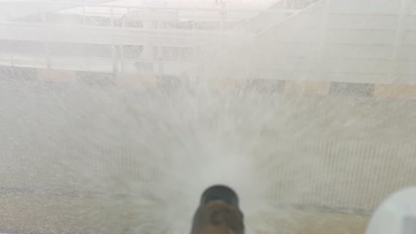 Deluge-sprinkler-nozzle-spraying-seawater-on-ships-deck-during-fire-drill---Closeup-slow-motion-with-upward-movement