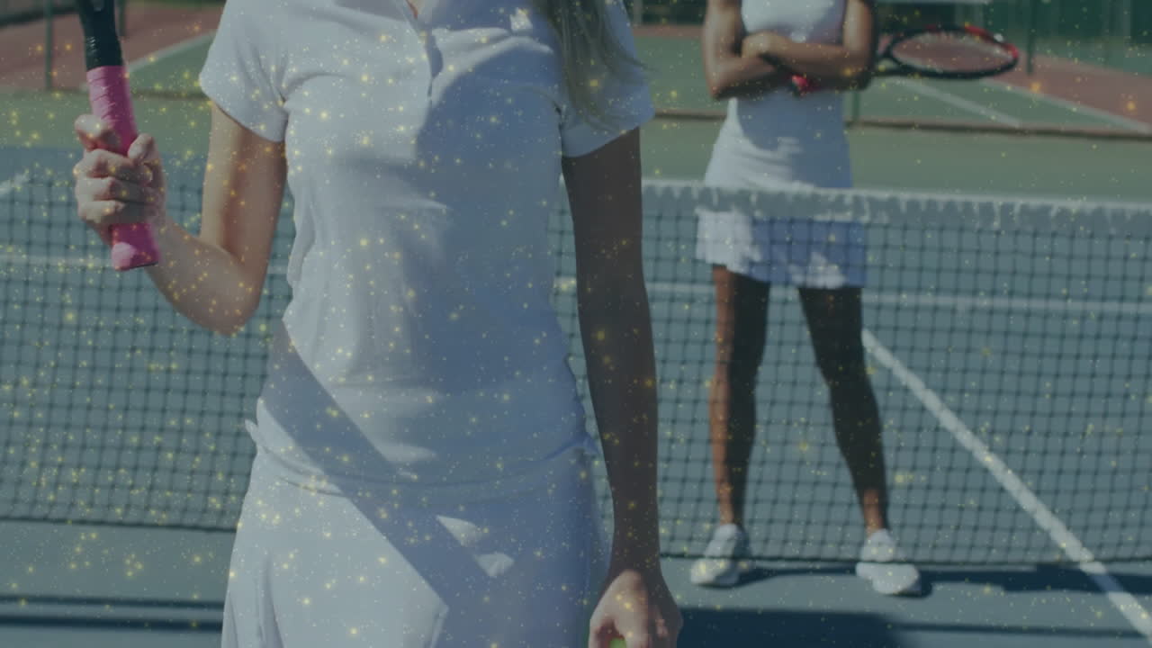 Two competitors gripping pink-grip rackets on tennis court, showing animated health chart overlay