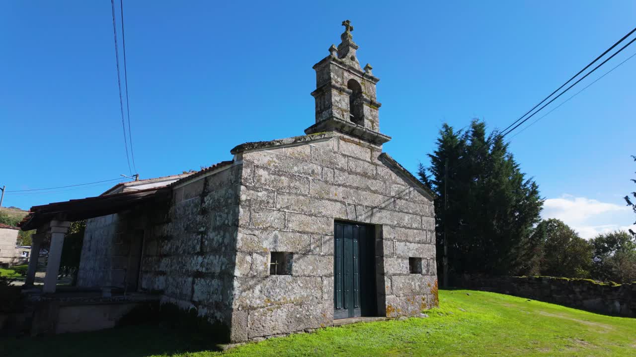 Side view of Santa Marta Chapel, showing bell tower and stone walls, Vilar de Santos, Ourense