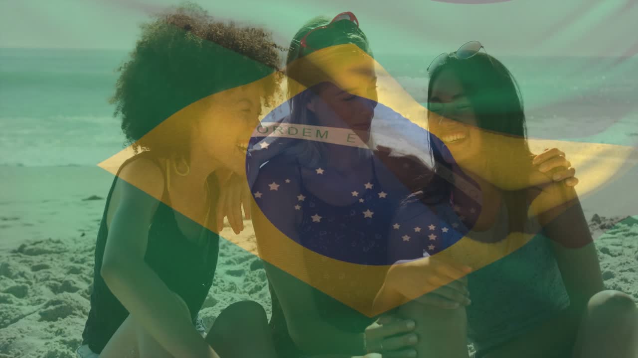 3 women beach leaning laughing, woman holding phone sharing travel moment under Brazil flag overlay
