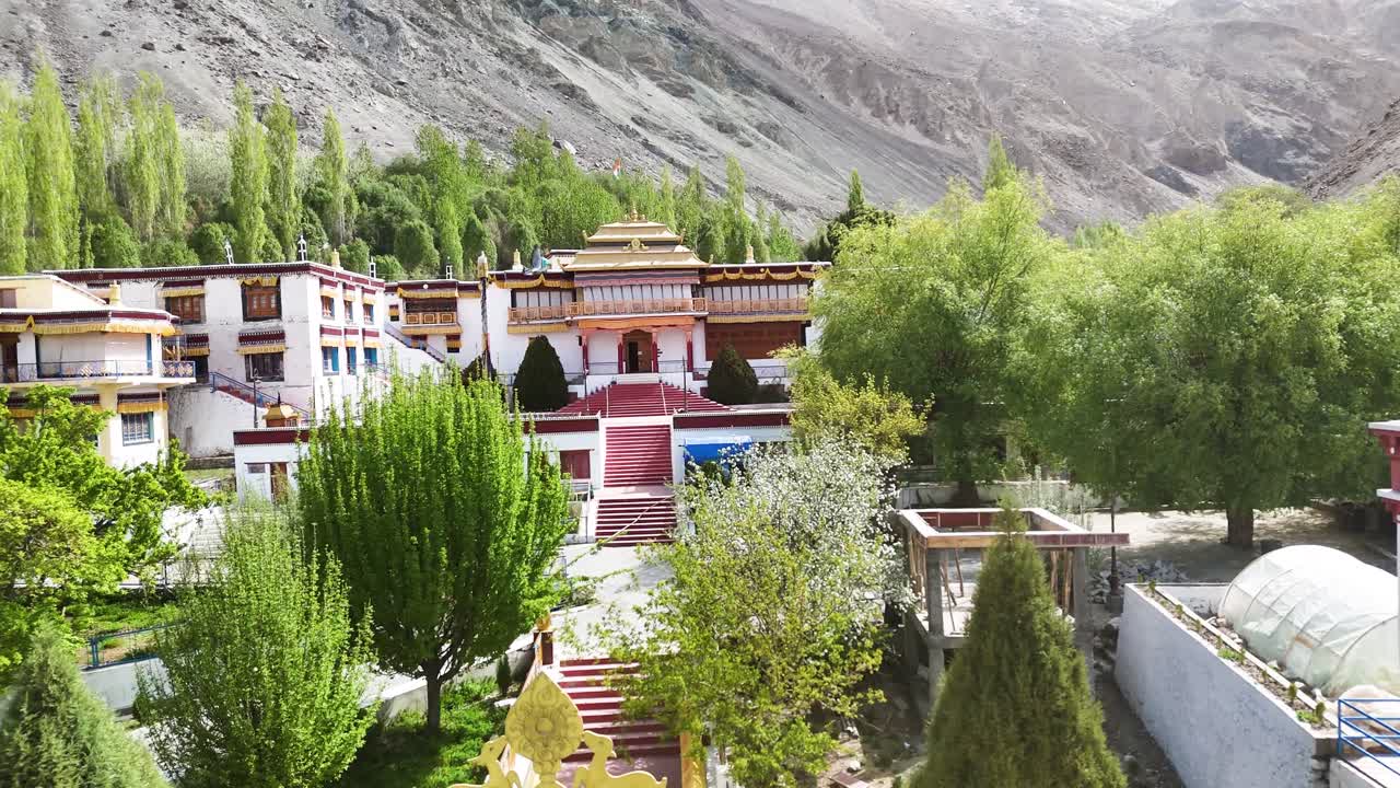 Aerial drone shot capturing the serene monastery in Sumur village, nestled amid the rugged landscapes of Nubra Valley.