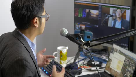 asia man livestreams using software and mic setup