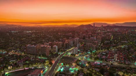 roundabout aerial hyperlapse, neon city night lights, violet golden sunset chile downtown car traffic, skyscrapers vibing andean cordillera