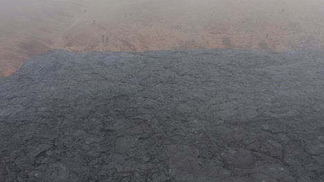 rain clouds above black basalt field in iceland valley, aerial