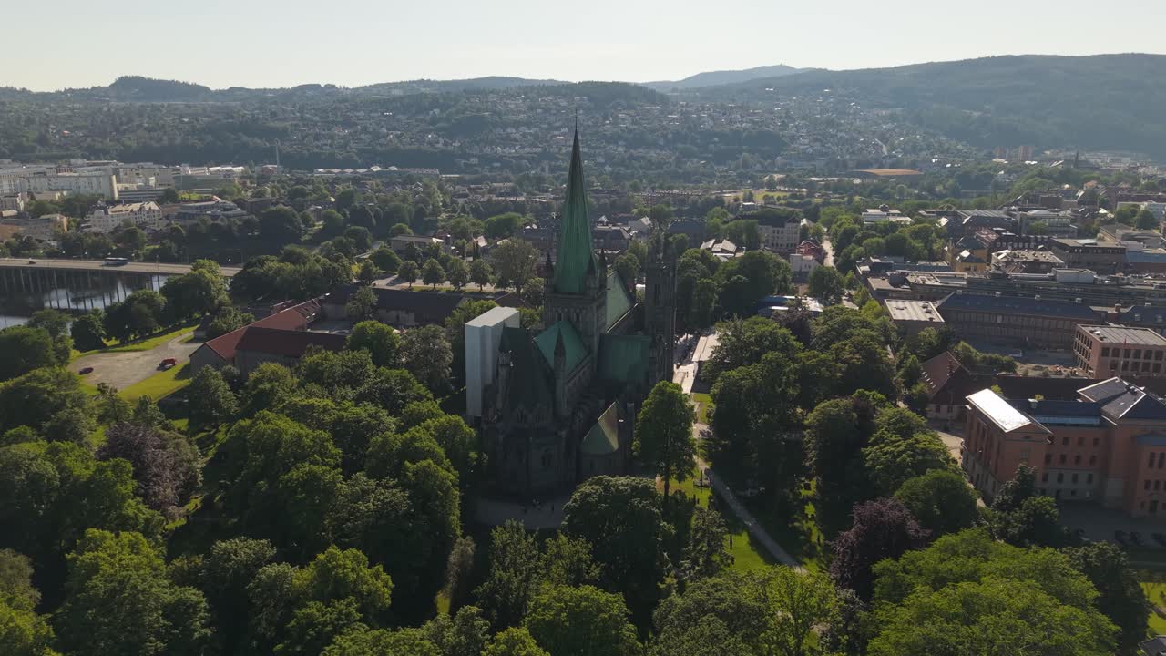 Nidaros Cathedral Rises Above Lush Green Parks and Surrounding Neighborhoods in Trondheim, Norway - Wide Shot