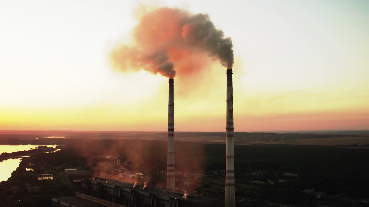 Plant pipes pollute atmosphere. Aerial drone view of high smoke stack