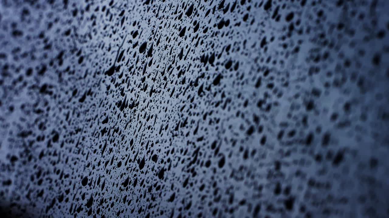 Close Up of Water Droplets on a Dark Glass Surface