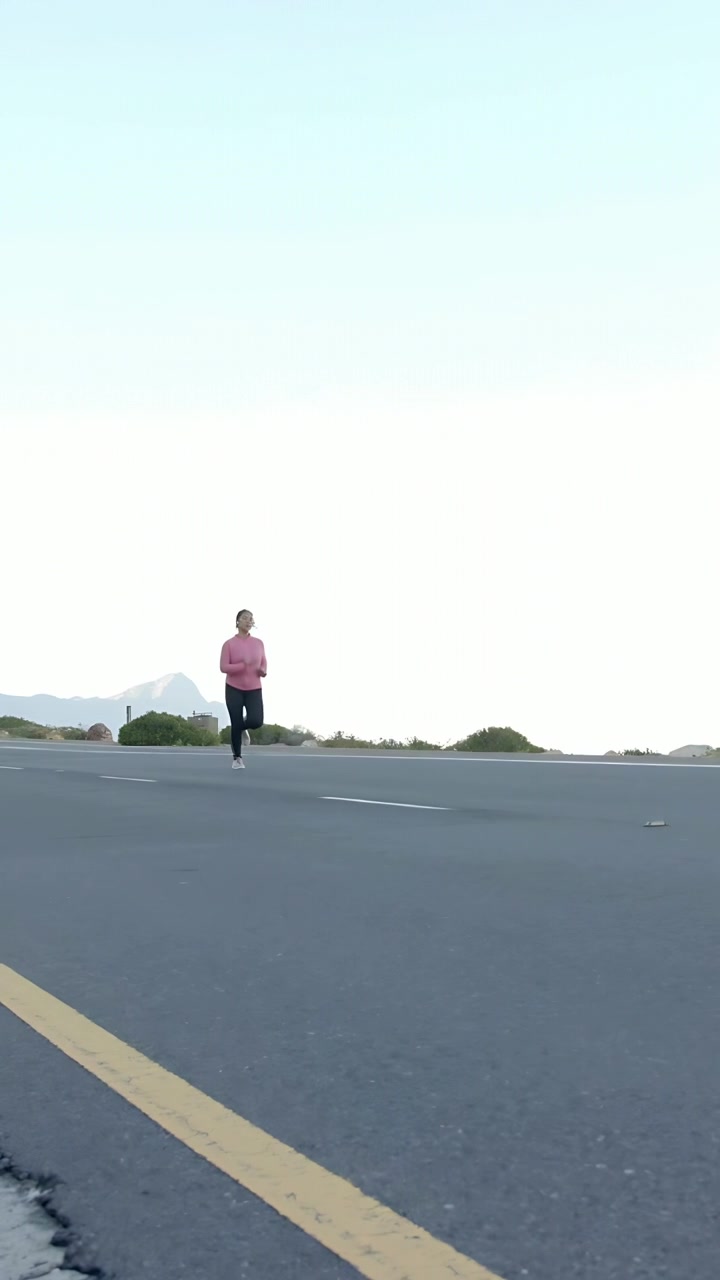 Vertical video: Runner approaching camera along road, grid globe moving to front as fitness overlay