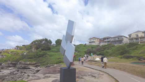 shadows of perception, crafted from aluminium and galvanized mild steel. sculpture by the sea bondi 2024, sydney nsw, australia. panning to the left.