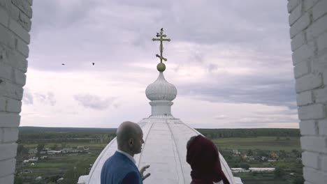 couple viewing church dome from tower