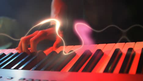 waves of light moving man playing keyboard at music concert