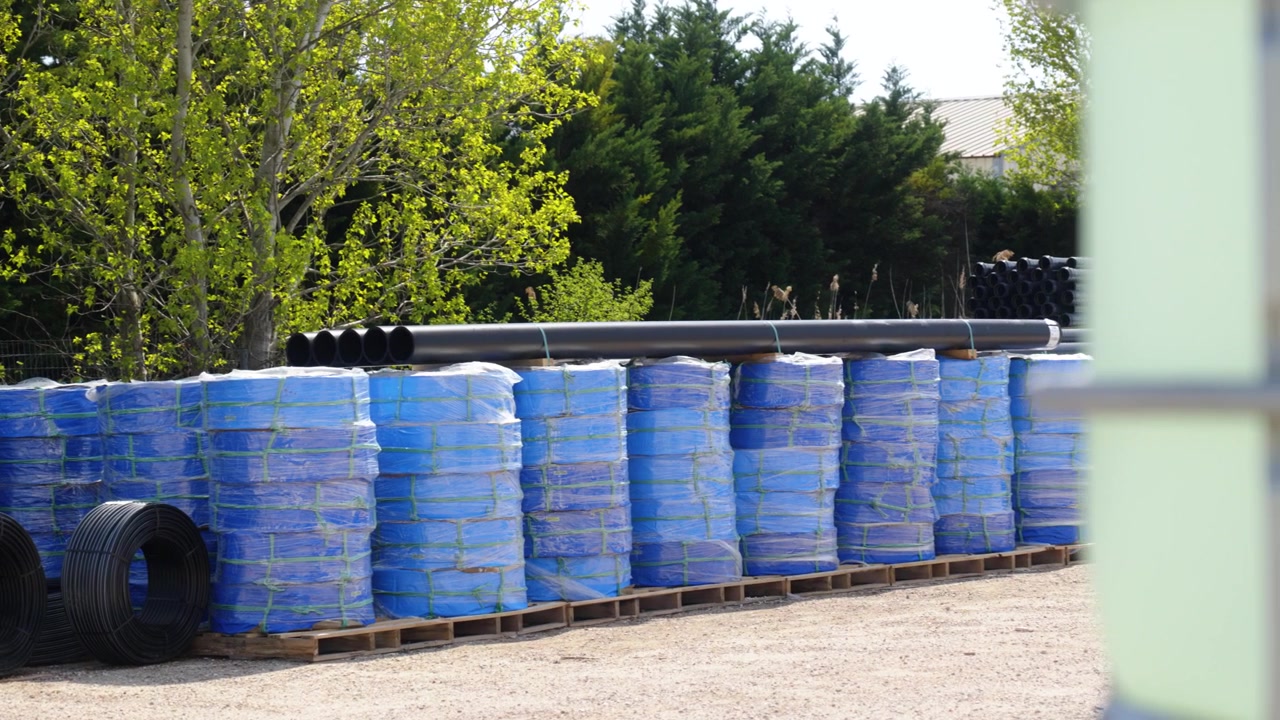Panning Shot of Irrigation Company Water Pipes and Agricultural Irrigation Supplies Warehouse Yard