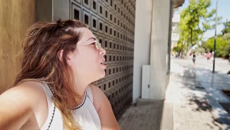 young woman vlogging on a sunny street in athens