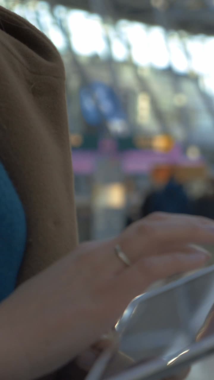 Person using phone at the airport