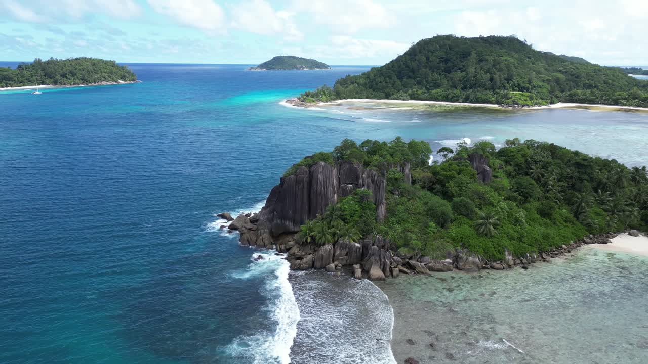Aerial view of Mahe Island in Seychelles, showcasing its stunning coastline, rocky outcrops. Circle Dolly Shot