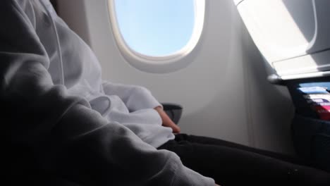 passenger with fastened seat belt seated on aircraft seat