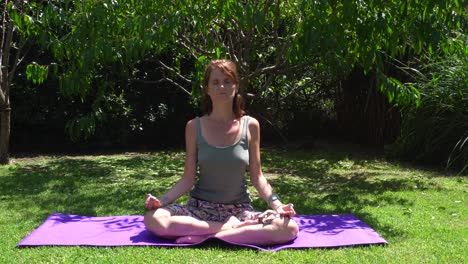 young caucasian woman breathes and relaxes during her daily yoga practice