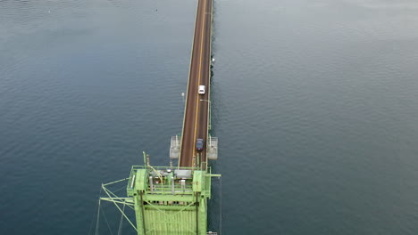 aerial view of a long bridge over water with vehicles