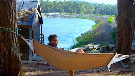 man relaxing in a hammock on a sunny day 4k