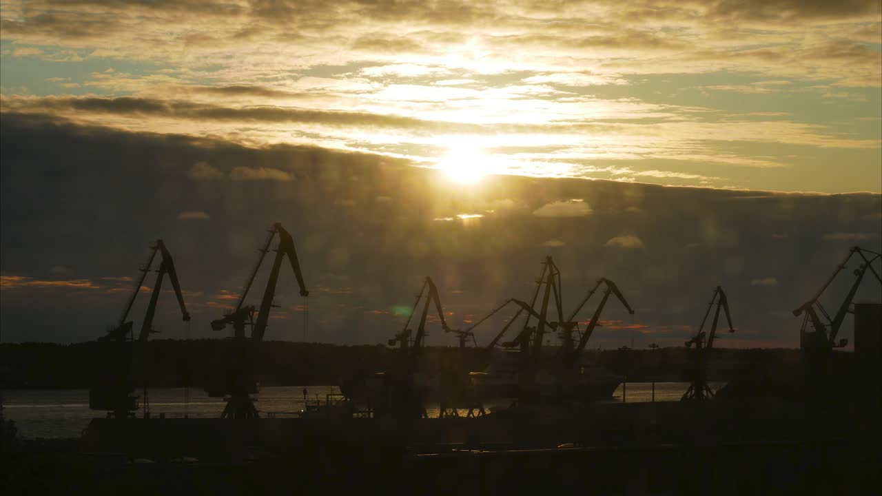 Klaiepda harbor timelapse with sun rays and beautiful white clouds.