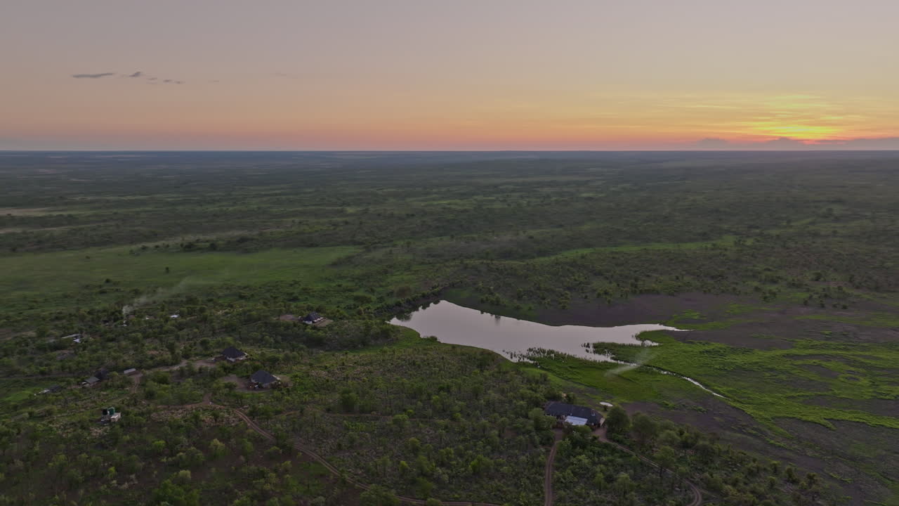 Hwange Park Zimbabwe Aerial v6 flyover around Nantwich safari lodges, capturing the sunset landscape of vast, verdant African open plains during wet season - Shot with Mavic 3 Pro Cine - Jan 4th 2024