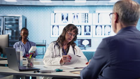 vertical video female specialist examining senior patient in cabinet discussing about recovery
