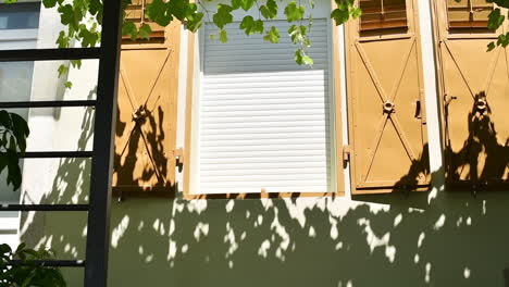 Geschlossenes-Fenster-Mit-Metallischen-Fensterläden,-Mediterraner-Baustil,-Sommernachmittag