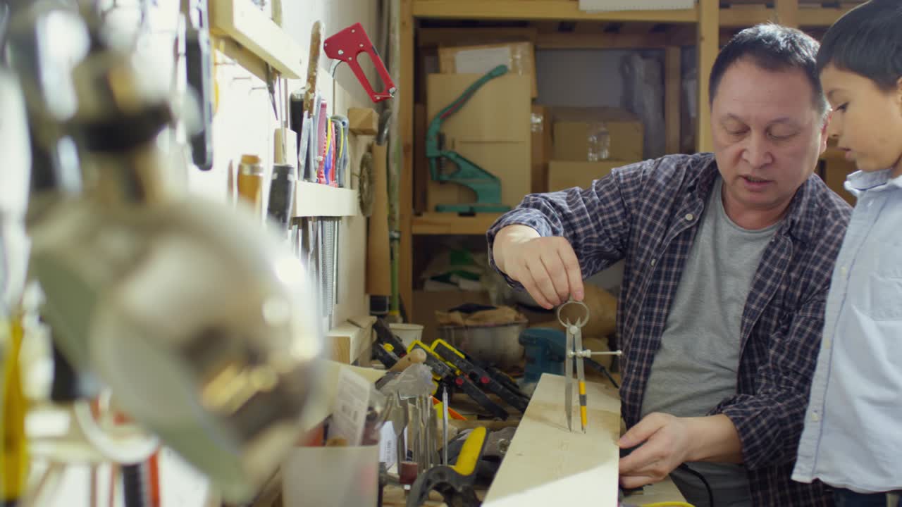 Father Showing Bow Compass to Little Son