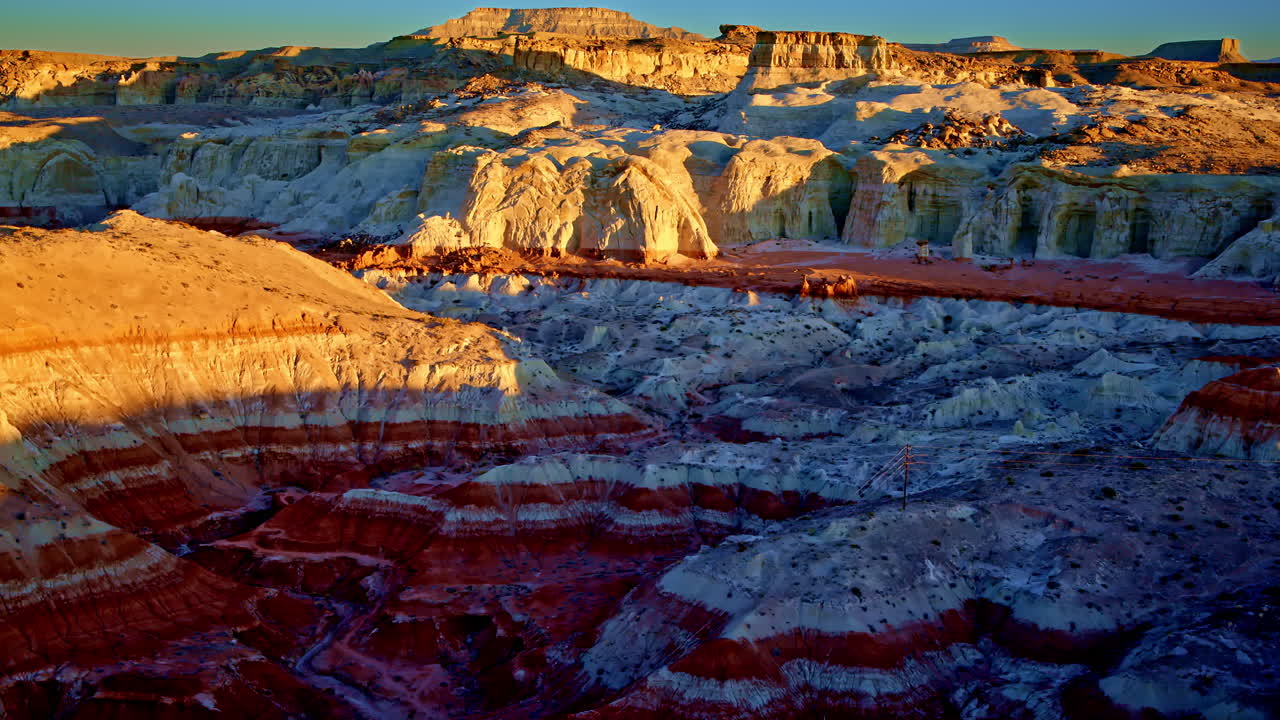The camera glides over a fantastical desert landscape shaped by time and lit in fiery color.